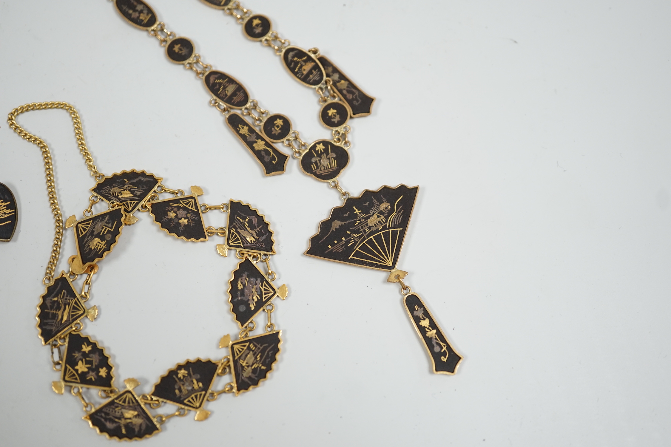 A Japanese gilt damascened iron work suite of jewellery: necklace, bracelet and a pair of cuff links